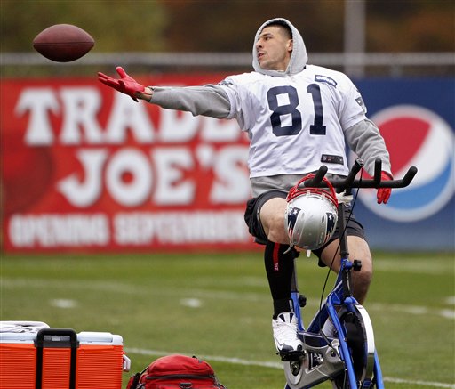 New England Patriots tight end Aaron Hernandez (81) can not hang onto the ball as he trys to catch a pass while riding a stationary bike during practice at the NFL football team's facility in Foxborough, Mass., Wednesday, Oct. 24, 2012. (AP Photo/Stephan Savoia) Gillette Stadium