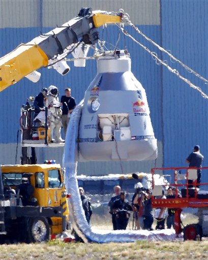 Felix Baumgartner, in pressurized suit on platform at left, prepares to enter the balloon capsule in Roswell, N.M., on Tuesday. The skydive attempt was later canceled due to high winds.