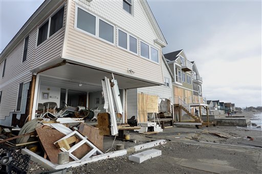 Wreckage lies outside damaged beachfront homes in the aftermath of superstorm Sandy in Milford, Conn., on Tuesday.
