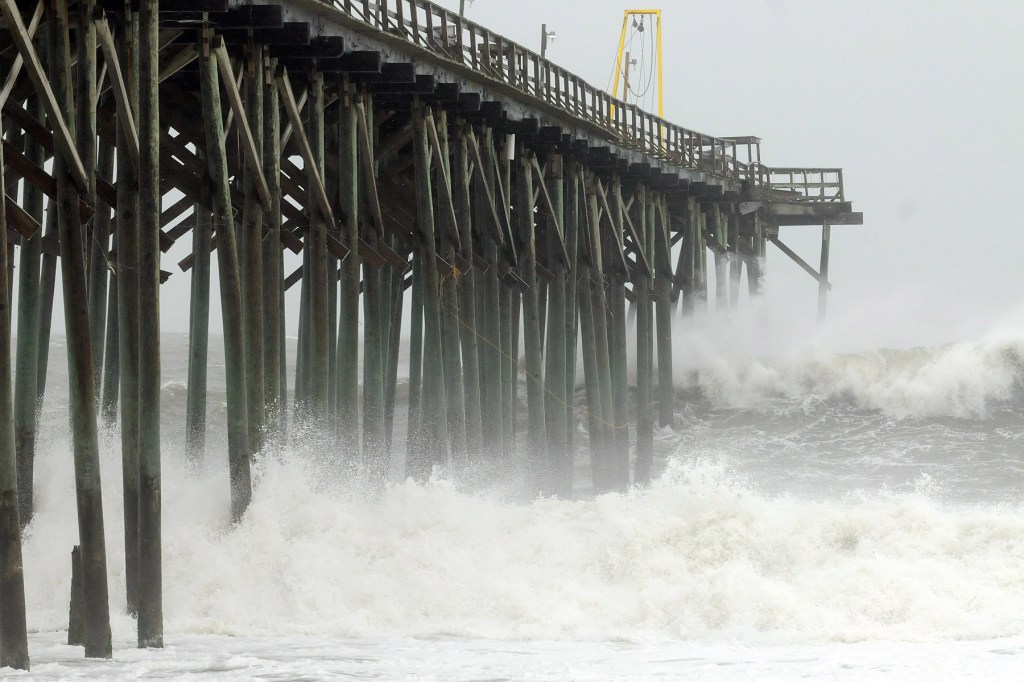 Waves pound Carolina Beach pier in Carolina Beach, N.C., Saturday, as Hurricane Sandy churns in the Atlantic Ocean. Hurricane Sandy, upgraded again Saturday just hours after forecasters said it had weakened to a tropical storm, was barreling north from the Caribbean and was expected to make landfall early Tuesday near the Delaware coast, then hit two winter weather systems as it moves inland, creating a hybrid monster storm.