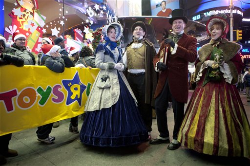 Carol-singers perform for customers waiting in line outside the Toys R Us in Times Square in New York last November. Americans' worries about the economy have led the National Retail Federation to predict slower growth during this holiday shopping season than the increase of 5.6 percent and 5.5 percent in 2010 and 2011, respectively.