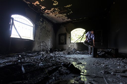 In this Sept. 13, 2012, photo, a Libyan man investigates the inside of the U.S. Consulate in Benghazi, after an attack that killed four Americans, including Ambassador Chris Stevens on the night of Tuesday, Sept. 11, 2012.