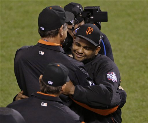 San Francisco Giants' Pablo Sandoval, right, is congratulated by manager Bruce Bochy after the Giants defeated the Detroit Tigers, 8-3, in Game 1 of the World Series on Wednesday in San Francisco. MLB