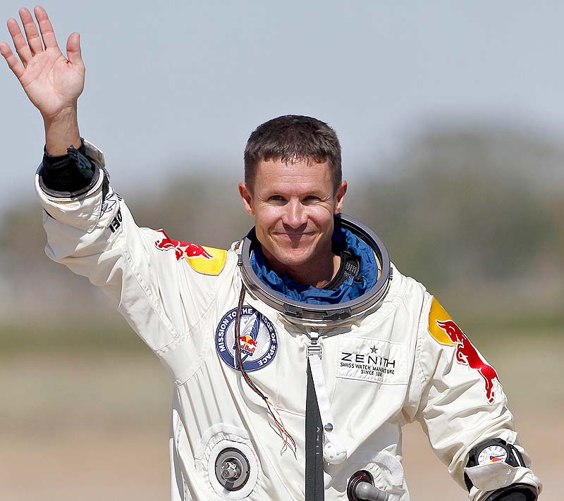 Felix Baumgartner waves to the crowd after successfully jumping from a space capsule lifted by a helium balloon at a height of just over 128,000 feet above the Earth's surface on Sunday.