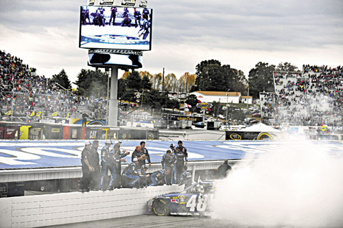 VICTORY LANE BOUND: Jimmie Johnson celebrates his win with a burnout with his crew after winning the NASCAR Sprint Cup Series race Sunday at Martinsville Speedway in Martinsville, Va.
