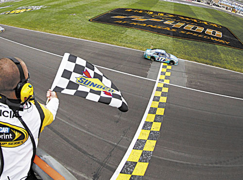 FIRST TO FINISH: Matt Kenseth (17) takes the checkered flag to win the NASCAR Sprint Cup Series race Sunday at Kansas Speedway in Kansas City, Kan.