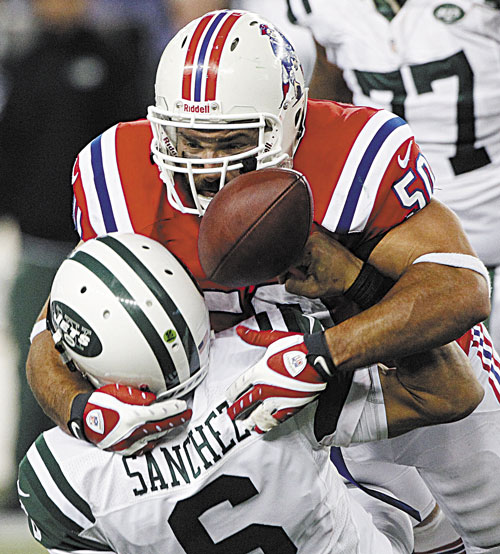 TAKEDOWN: New England Patriots defensive end Rob Ninkovich (50) causes a fumble when he sacks New York Jets quarterback Mark Sanchez to clinch a 29-26 Patriots win in overtime Sunday in Foxborough, Mass.