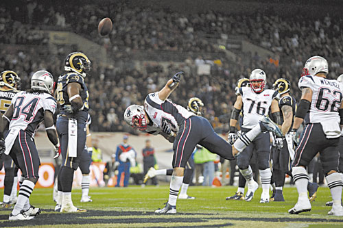 TAKE THAT: New England Patriots tight end Rob Gronkowski, center, celebrates after scoring a touchdown against the St. Louis Rams during the first half Sunday at Wembley Stadium in London.