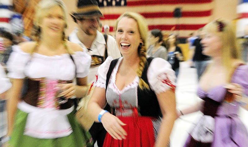 Staff photo by Joe Phelan Patty Zavaletaa, of Hancock, center, said that she got the dirndl dress she is wearing while visiting Germany. She was posing with other costumed festival goers on Saturday during the Central Maine International Octoberfest at the Augusta Armory. Behind her from left are Lauren Lear, Alex Lear and Sue Magee.