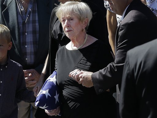 This photo taken Sept. 19, 2012 shows Barbara Doherty, mother of slain former Navy SEAL Glen Doherty, escorted from the Church of St. Eulalia in Winchester, Mass., after his funeral. What do a Navy mom, Big Bird and AARP have in common? They all want President Barack Obama and Republican Mitt Romney to leave them alone. The two candidates are drawing on personal stories and pop culture references in campaign ads, daily speeches and debate zingers as each seeks to cast himself as an �everyman� and broaden his appeal in the presidential race's closing weeks. But they're encountering resistance at seemingly every turn by a broad collection of people they mention and entities they reference. And this year, the complaints go beyond those that usually occur during campaign years: griping by musical groups whose songs candidates use at rallies. (AP Photo/Elise Amendola)