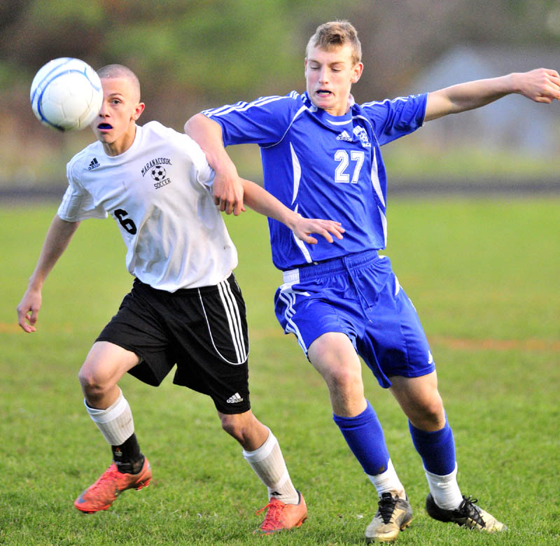 GET BACK HERE: Maranacook’s Kody Solmitz, left, and Yarmouth’s Hugh Grygiel battle for the ball during a playoff game Saturday evening at the Ricky Gibson Field of Dreams at Maranacook Community School in Readfield.