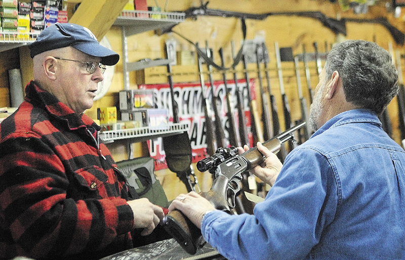 Owner Gary Hamilton, left, chats with Ted Seney, of Vassalboro, about scopes and ammunition on Thursday afternoon at Neilsen's Sporting Goods in Farmingdale. Seney said that he was getting ready for firearms deer hunting season which opens this Saturday for Maine residents only. The season runs from Monday October 29 to Saturday November 24th.