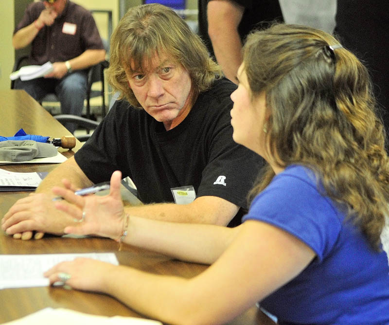 David Lehoux, left, talks to Beverly Robbins, of Preble Street Resource Center about transitional housing during the annual Maine Homeless Veterans Stand Down on Saturday at the VA Healthcare Systems Maine Medical Center - Togus.