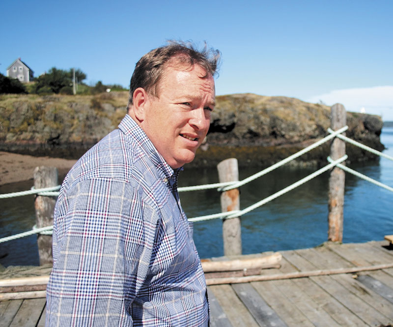 State Senate President Kevin Raye strolls a pier overlooking Cummings Cove on Passamaquoddy Bay during a recent tour of his native Eastport. The pier is home to Eastport Chowderhouse, where Raye worked as a server during his teen years. Raye, a Republican, is running against Democratic incumbent Mike Michaud for the U.S. House of Representatives in Maine's 2nd Congressional District.