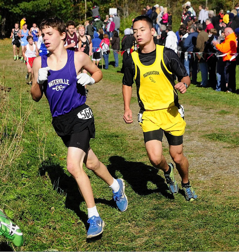 Waterville's Billy Chambers, left, and Maranacook's Koji Kobayashi round a curve during KVAC cross country meet on Saturday morning at Cony High School in Augusta.