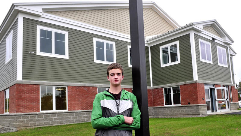 Albert Joseph Languet IV, 17, of Belgrade, stands outside the new Mid-Maine Homeless Shelter in Waterville. Languet is planning, designing and raising money for a playground there.