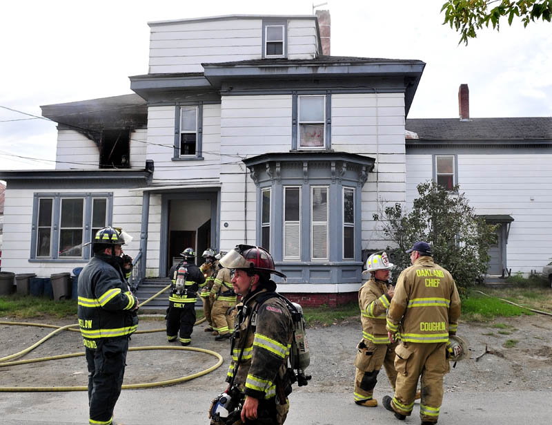 Firefighters from several area departments extinquish a fire that caused serious damage to an apartment building on Western Avenue in Waterville late Tuesday afternoon.