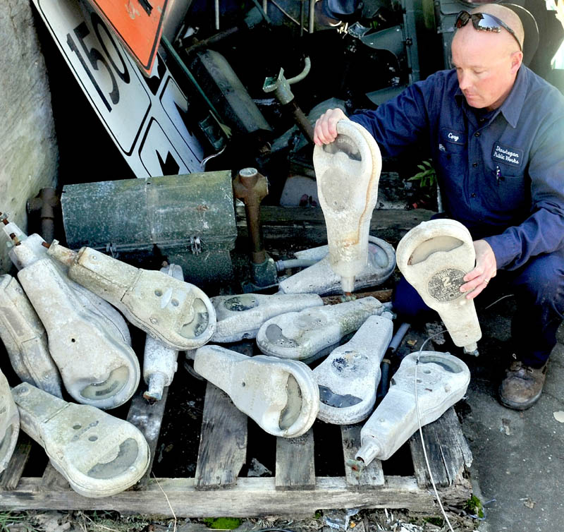 Corey Johnson looks over some of Skowhegan's long-unused parking meters, which the town is now selling.