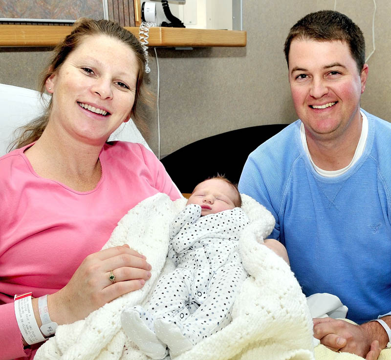 HAPPY FAMILY: Heather and Glenn Adams and their newborn son, Reed, at Thayer Hospital in Waterville on Thursday. Reed entered the world before dawn with some assistance from Waterville police dispatcher Sarah Bailey, who coached Glenn over the phone on delivering a baby.