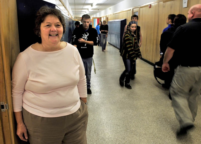 Julie Richard stands back as students move between classes at Upper Kennebec Valley Memorial High School in Bingham. Richard is the new principal at the school and both Quimby Middle and Moscow Elemenatary schools.