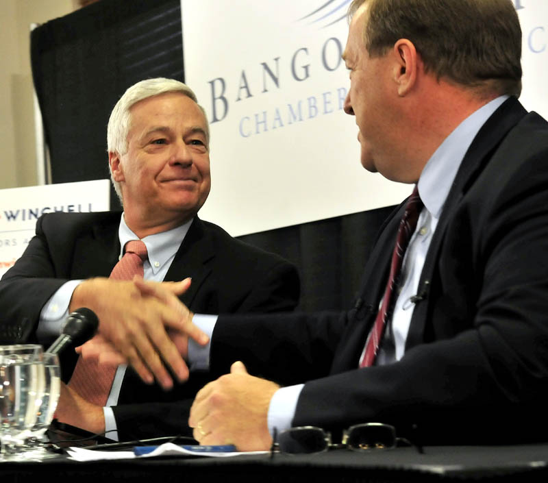 Staff photo by David Leaming U.S. Rep. Mike Michaud, left, and challenger Sen. Kevin Raye shake hands following a debate in Bangor on Tuesday.