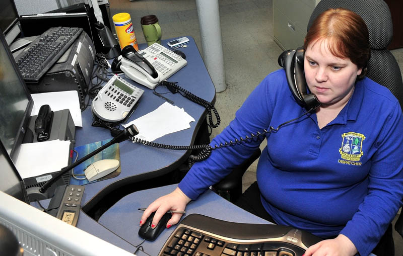 Waterville police dispatcher Sarah Bailey takes an emergency call at the department on Thursday. Earlier, Bailey coached Glenn Adams, of Oakland, through helping his wife, Heather, deliver their son.