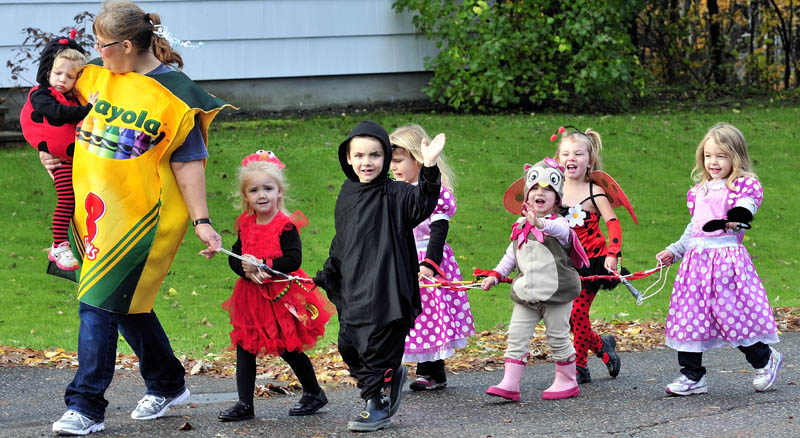 HAPPY HALLOWEEN: Children with the Happy Hearts daycare led by Judy DeFelice, go on an early Halloween parade along Johnson Heights in Waterville this morning.