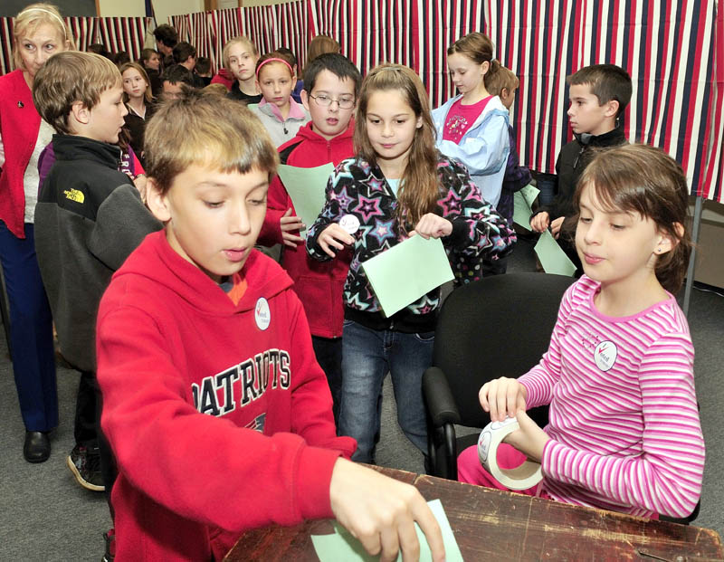 Students from the Margaret Chase Smith school in Skowhegan cast their ballots during a statewide mock election at the Municipal Office on Tuesday. Ballot clerk Alivia Rac, right, monitors as Chris Allmendinger and Emma Duffy cast their ballots. The students elected Barack Obama for president, Michael Michaud for Congress and Angus King for U.S. Senate.