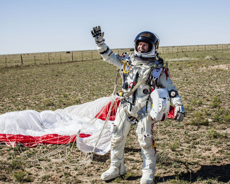 Felix Baumgartner of Austria celebrates after coming down in the eastern New Mexico desert minutes after jumping from his capsule more than 24 miles above the Earth.