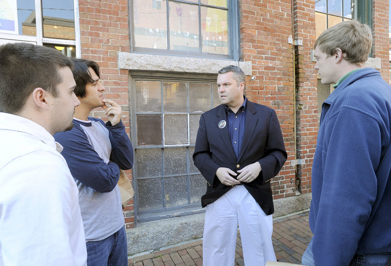Jon Courtney, Republican candidate for Maine’s 1st District House seat, chats with Josh Leger, Tim Bremm and Mike Brown in Portland’s Old Port last week.