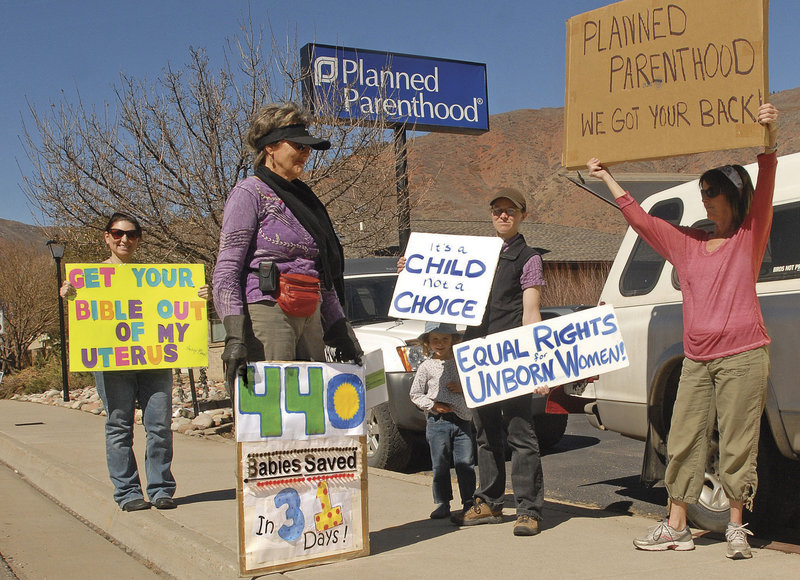 Advocates from both sides of the abortion issue share the sidewalk next to the Planned Parenthhood clinic in West Glenwood, Colo., in March.