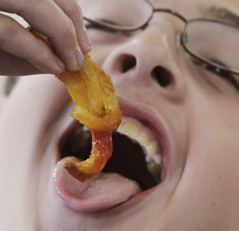 A student eats french fries at lunch at Gardiner Area High School in Gardiner. Tea party websites deride the new cap on school lunch calories as government overreach, even though there have been nutritional standards since the school lunch program was created in 1946.