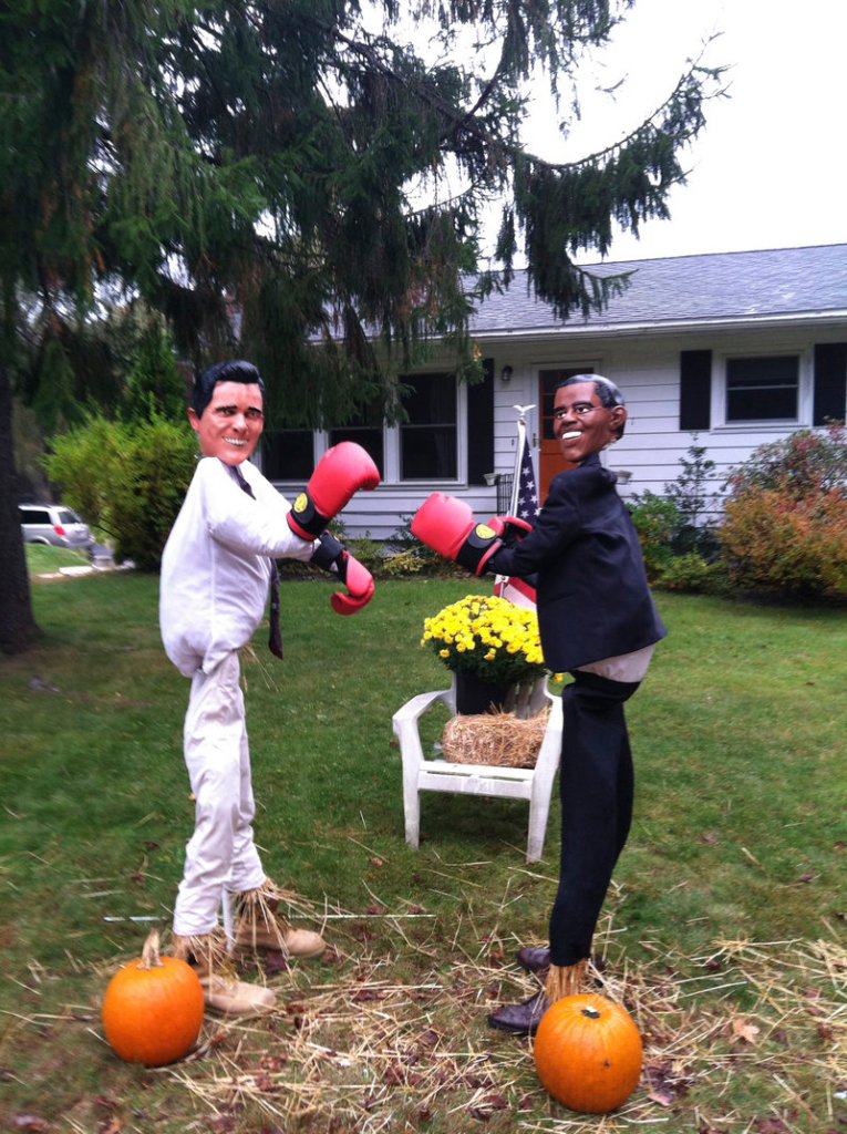 Michele Tobey of Cape Elizabeth uses Obama and Romney masks on these scarecrows, which she’s entered in a local contest. She often finds cars stopped in the street with passengers taking pictures of the figures.
