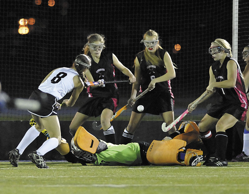 Skowhegan High School field hockey player Brooke Michonski (8) fires a shot over Scarborough goalie Shannon Hicks in the firts period of their State Class A Championship game in Orono, Maine, Saturday, Oct.27, 2012.