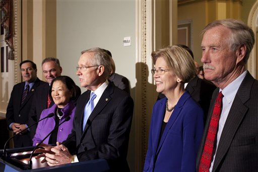 Senate Majority Leader Harry Reid of Nev., center. accompanied by incoming Senate Democrats, speaks during a news conference on Capitol Hill in Washington, Wednesday, Nov. 14, 2012. From left are, Sen.-elect Joe Donnelly, D-Ind., Sen.-elect Tim Kaine, D- Va., Sen.-elect, current Rep. Mazie Hirono, D-Hawaii, Reid, Sen.-elect Elizabeth Warren, D-Mass.,and Sen. -elect Angus King, I-Maine, who will caucus with the Democrats. (AP Photo/Harry Hamburg)
