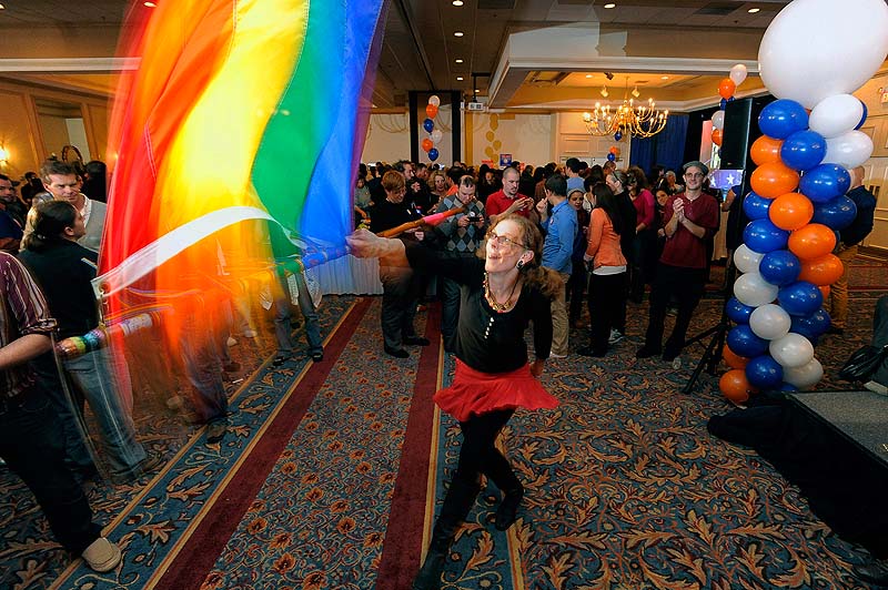 Angel Putney of Portland, who said she usually twirls fire, took to twirling a gay pride flag while waiting for election results at the Mainers United for Marriage Campaign party at the Holiday Inn by the Bay Tuesday, November 6, 2012.