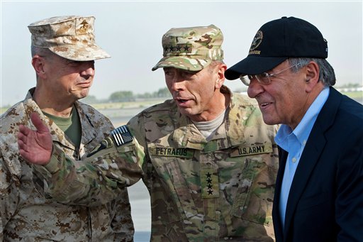 In this July 9, 2011 file photo, USMC Gen. John Allen, left, and Army Gen. David Petraeus, top U.S. commander in Afghanistan and incoming CIA Director, greet former CIA Director and new U.S. Defense Secretary Leon Panetta, right, as he lands in Kabul, Afghanistan, Saturday, July 9, 2011. (AP Photo/Paul J. Richards, Pool)