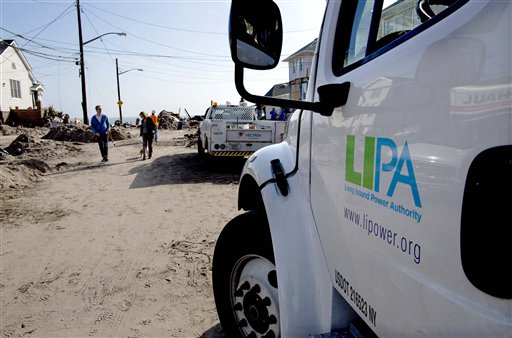 A Long Island Power Authority (LIPA) truck is seen in the Belle Harbor neighborhood of the borough of Queens, New York, Monday, Nov.12, 2012, in the wake of Superstorm Sandy. More than 70,000 customers of Long Island Power Authority in New York were without electricity Monday, two weeks after Superstorm Sandy struck. (AP Photo/Craig Ruttle)