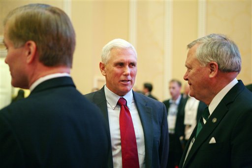 Indiana Governor-Elect Mike Pence, center, speaks with Georgia Gov. Nathan Deal, right, prior to a panel discussion during the 2012 RGA Annual Conference at Encore hotel-casino Thursday, Nov. 15, 2012, in Las Vegas. (AP Photo/Ronda Churchill)
