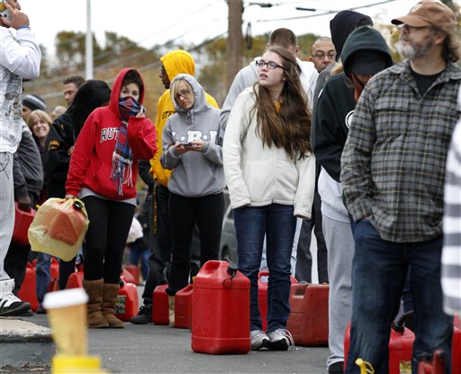 As temperatures begin to drop, people wait in line to fill gas containers at a Shell station in Keyport, N.J., on Thursday. In parts of New York and New Jersey, drivers lined up for hours at gas stations that were struggling to stay supplied.