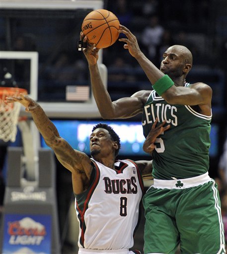 Milwaukee Bucks' Larry Sanders (8) tries to steal the ball from Boston Celtics' Kevin Garnett (5) during the second half of an NBA basketball game, Saturday, Nov. 10, 2012, in Milwaukee. The Celtics defeated the Bucks 96-92. (AP Photo/Jim Prisching)