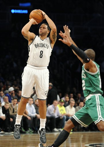 Brooklyn Nets' Deron Williams (8) shoots around Boston Celtics' Leandro Barbosa (12) in the first half of a basketball game on Thursday, Nov., 15, 2012, at Barclays Center in New York. The Nets won 102-97. (AP Photo/Kathy Kmonicek)