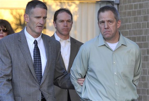 JetBlue pilot Clayton Frederick Osbon, right, is escorted to a waiting vehicle by FBI agents as he is released from The Pavilion at Northwest Texas Hospital, in Amarillo, Texas, in this In this April 2, 2012, photo. Osbon was charged with interference with a flight crew for his behavior on the March 27 flight from New York to Las Vegas.