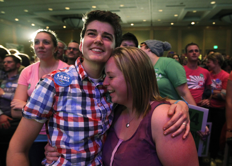Whitney Young, left, embraces her partner Marlena Blonsky as they listen to speeches at an election watch party for proponents of Referendum 74, which would uphold the state's new same-sex marriage law, Tuesday, Nov. 6, 2012, in Seattle. (AP Photo/Elaine Thompson)
