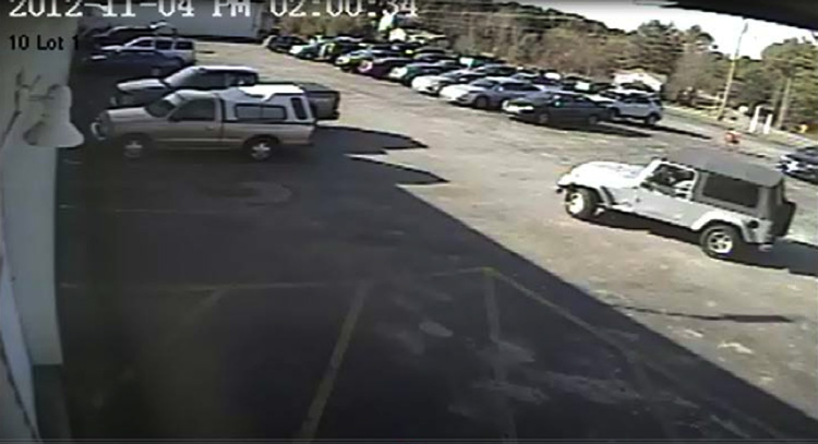 This image from a surveillance video shows the Jeep Wrangler police believe the suspect got into after the robbery.