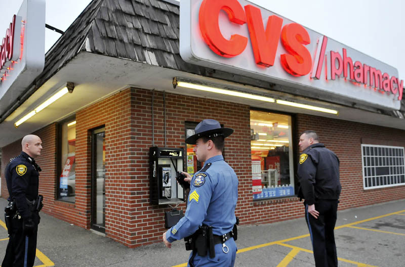 Augusta and state police surround the CVS pharmacy on Capitol Street in Augusta on Wednesday, after the store was robbed of narcotics. Police tracked the suspect with a dog.