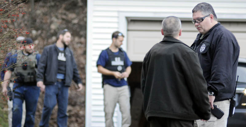 U.S. Marshal Service investigators search the residence of Barbara Cameron, the ex-wife of fugitive James Cameron, in Hallowell on Nov. 20. Authorities continue to hunt for Cameron, Maine’s former top drug prosecutor, who cut off his electronic monitoring bracelet and fled after learning his appeal of child pornography convictions had failed earlier this month.