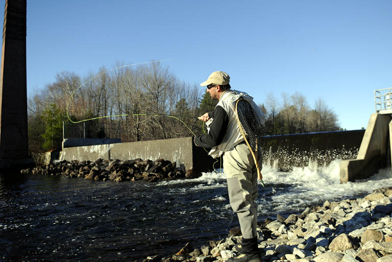 Chris Rollins casts a streamer Wednesday at the dam on Echo Lake in Mount Vernon. The angler, who cast flies across the western United States this summer, was searching for spawning trout and salmon in tail waters across Kennebec County.