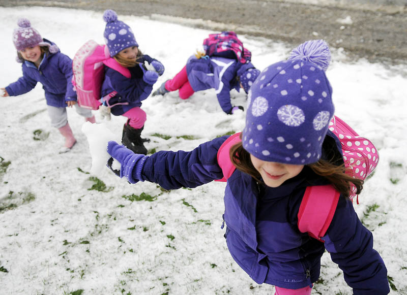 Abby Perry, 5, winds up to deliver a snowball Thursday while brawling with her twin sister, Emma, second from left, and cousins, Marinn Perry, 4, left, and Grace Perry, 6, at their grandparents' Hallowell farm. The children were waiting for a bus to deliver them to school that was delayed two hours by the first snowfall of the season.
