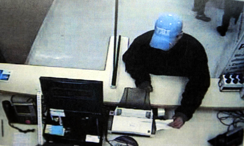 A security camera photo of a man who robbed the pharmacy of the Walmart in Augusta on Monday. He was was described as a young, white man about 5 feet 7 inches tall and wearing a blue coat and a blue baseball cap.